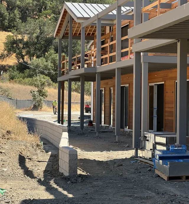 Retaining wall installation and exterior framing & finish work in progress