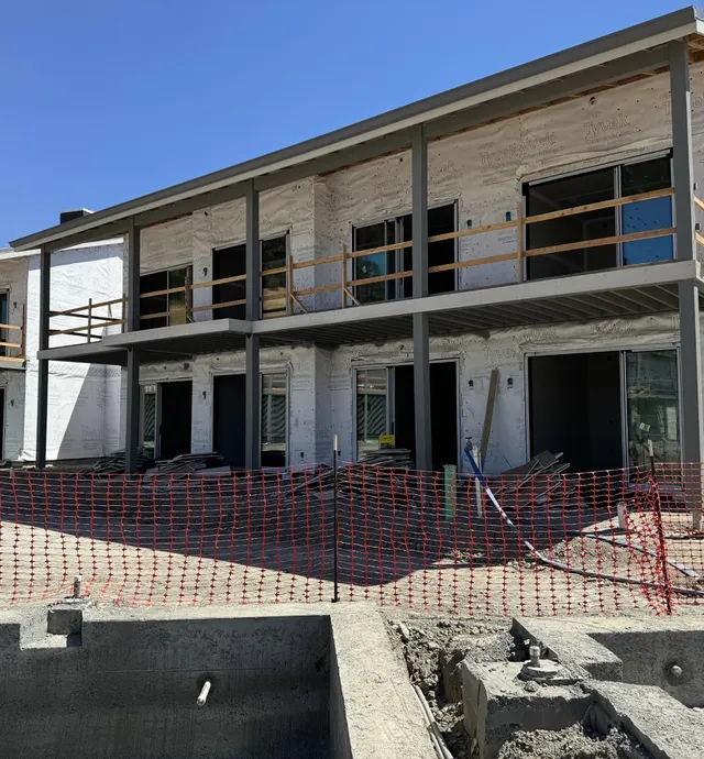 Large sheets of Tyvek wrapped around the outer structures of the buildings
