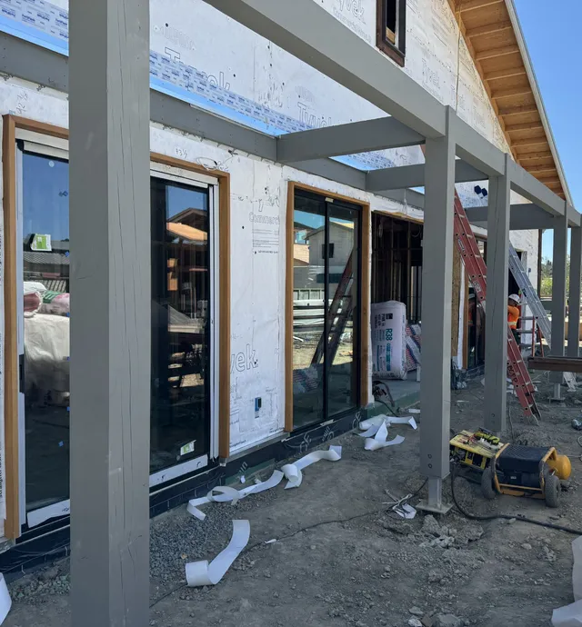 Sliding doors installation and Tyvek siding applied to exterior walls