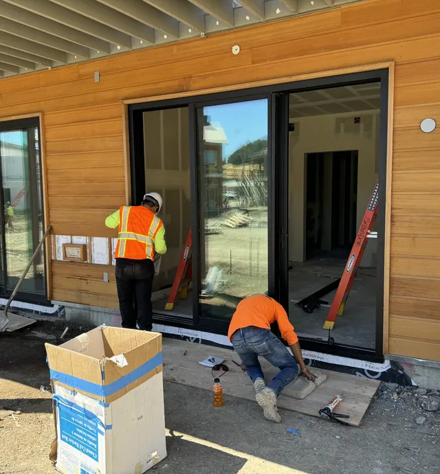 Subcontractors installing sliding doors